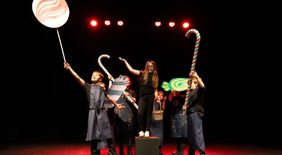 Children performing with oversized props